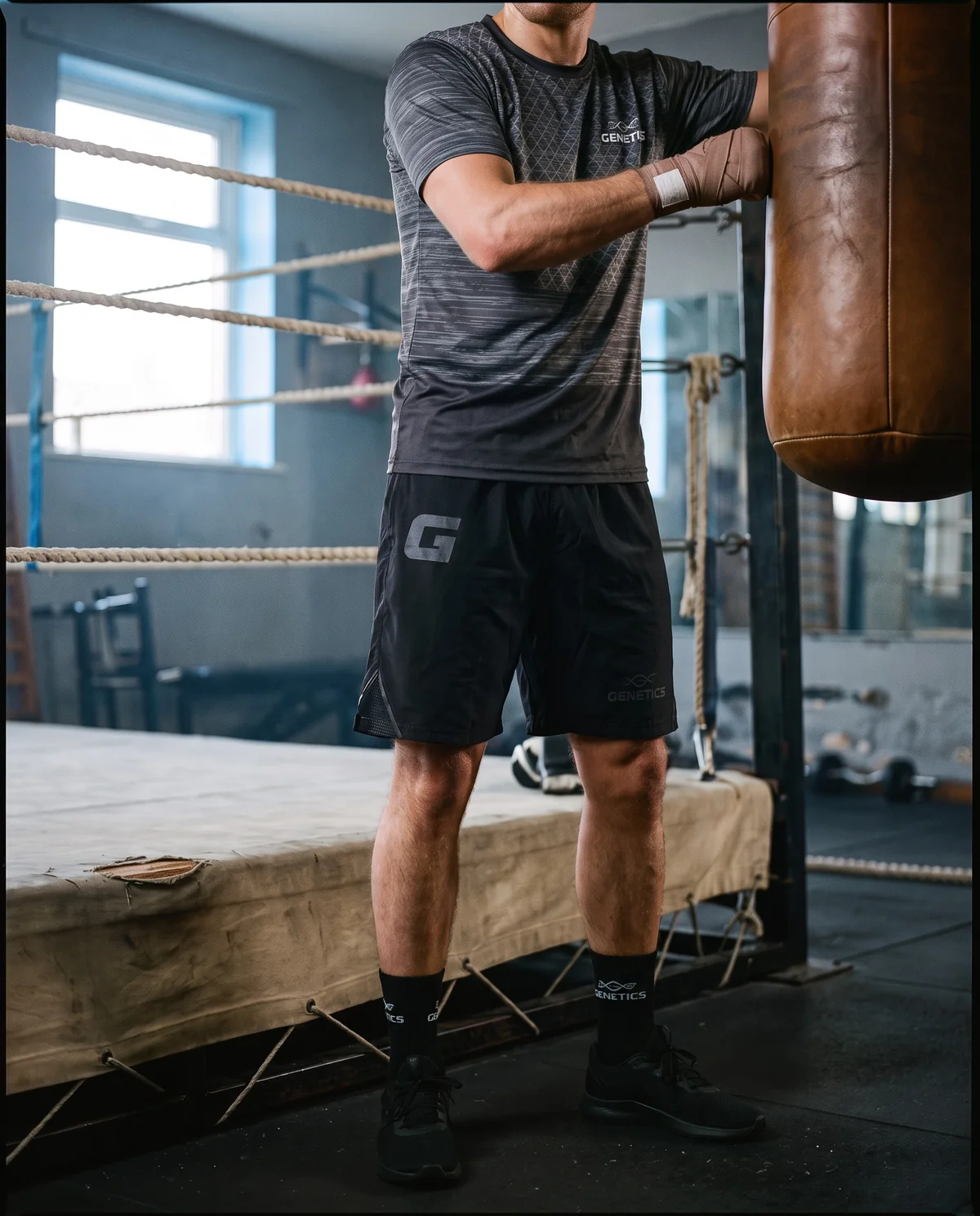 Genetics training kit, Grey, worn in a boxing gym beside a heavy bag